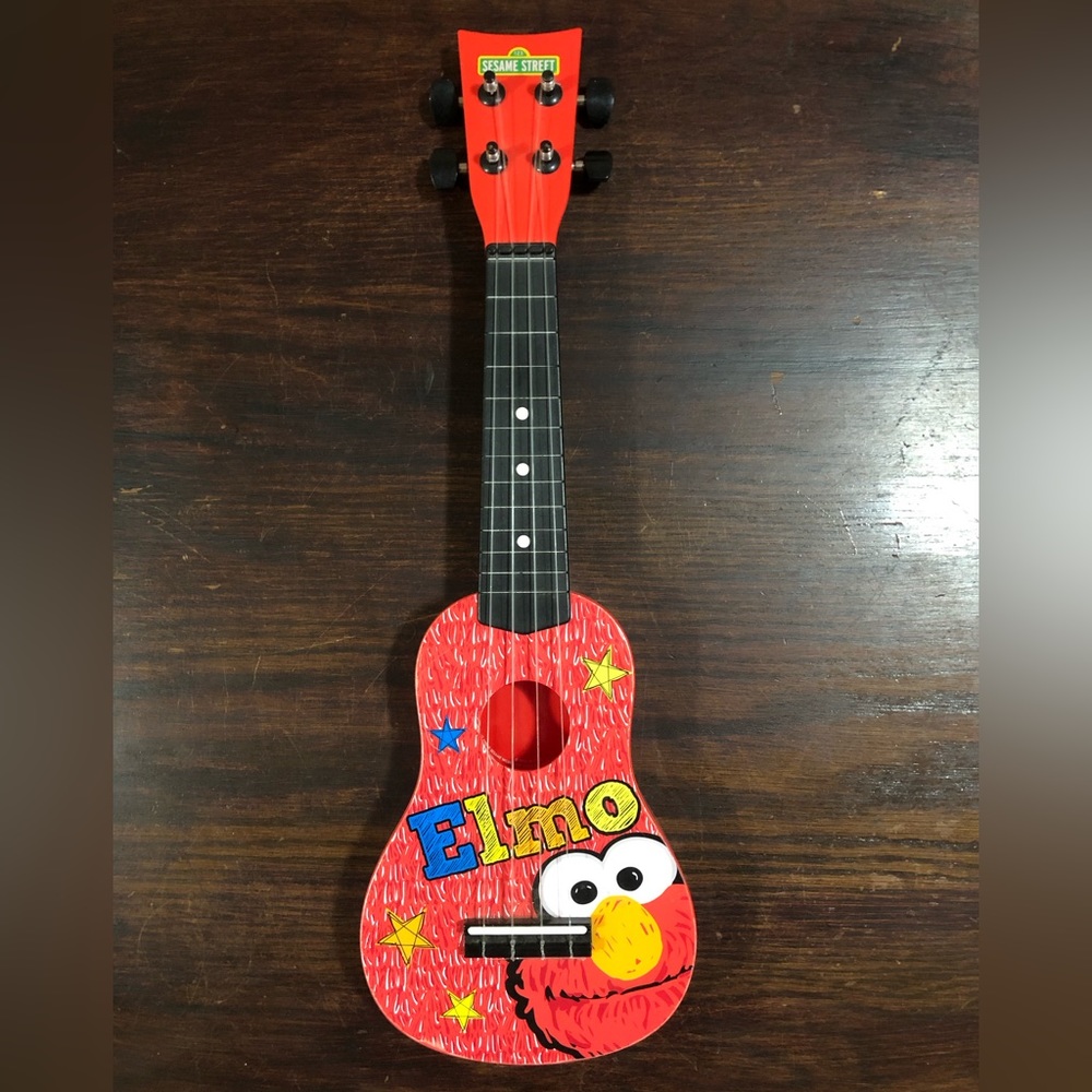 Elmo Sesame Street Ukulele by First Act 20”  Elmo Red Small String Guitar ￼￼ ￼